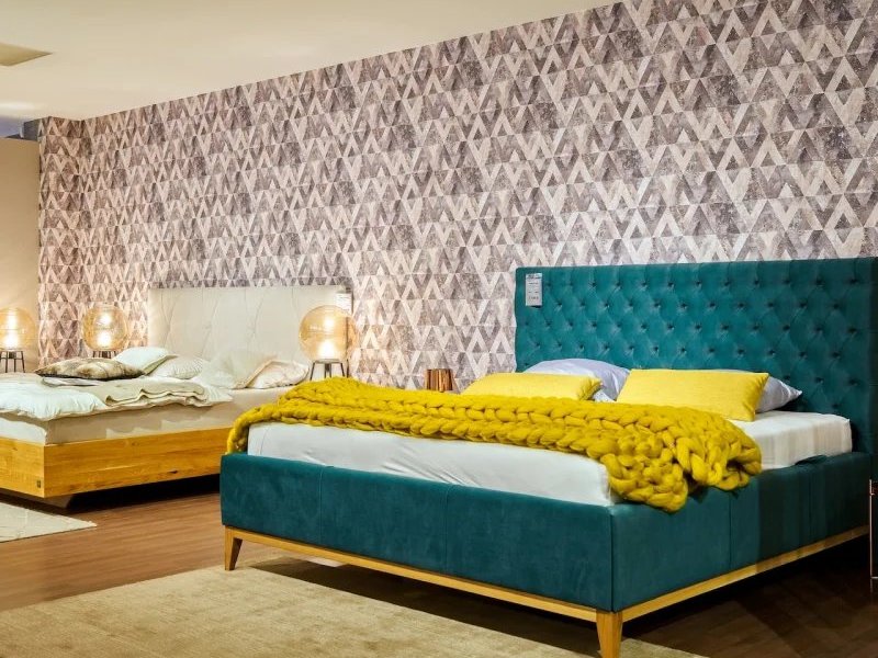 Blue area rug under a white bed in a tropical bedroom